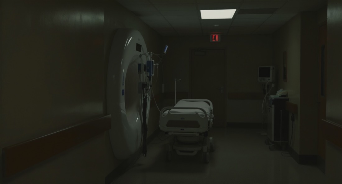 A quiet hospital corridor leading to an imaging suite